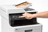 MFP color laser with color output and person pressing touchscreen